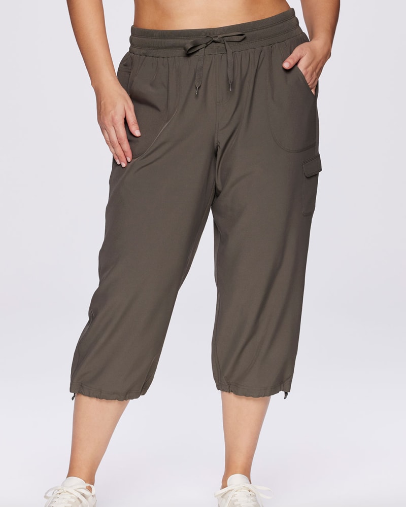 Front of a model wearing a size 3X Plus Prime Anywhere Cargo Capri in Olive by RBX Active. | dia_product_style_image_id:294442